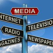 Image of a street sign pointing to multiple types of media