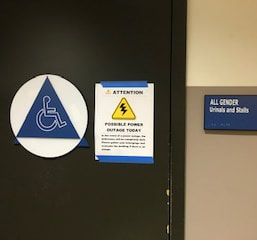 Photo of all gender restroom signage in AC building.
